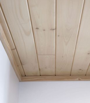 wood paneling ceiling with white walls