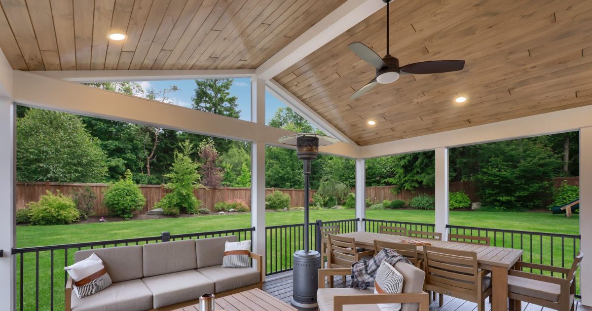 outdoor covered deck ceiling with white beams and patio furniture