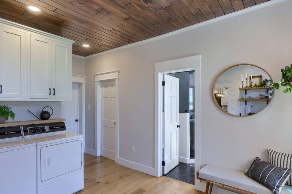 a kitchen with a wood paneling ceiling