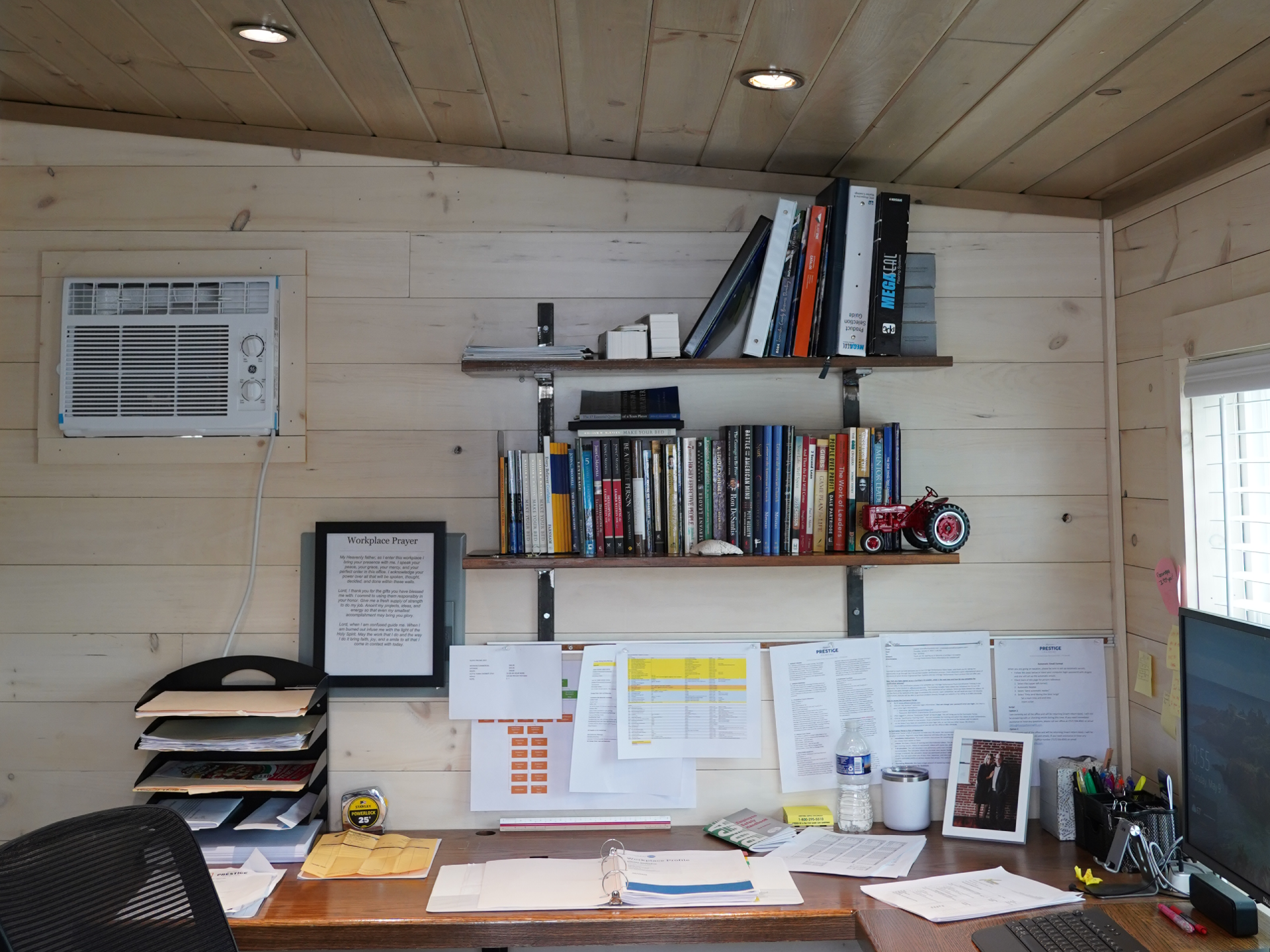 Home office with light wood planked walls and ceiling, showcasing a warm and rustic aesthetic ideal for workspaces or cabin-style interiors.