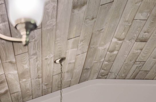 whitewashed vintage brown wood ceiling with chandelier light fixture hanging down