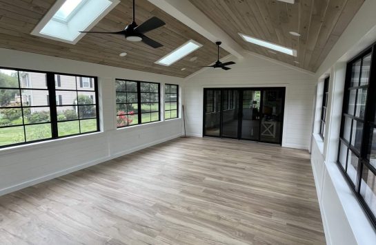 modern sunroom with skylights ceiling fans and ceiling finished in prefinished wood paneling