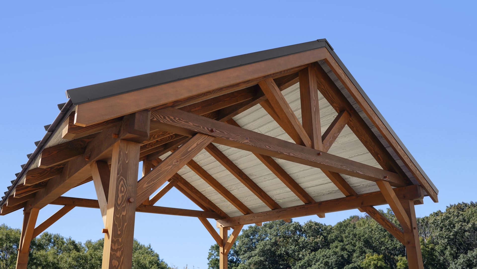 outdoor pavilion roof with exposed beams and tongue and groove ceiling planks